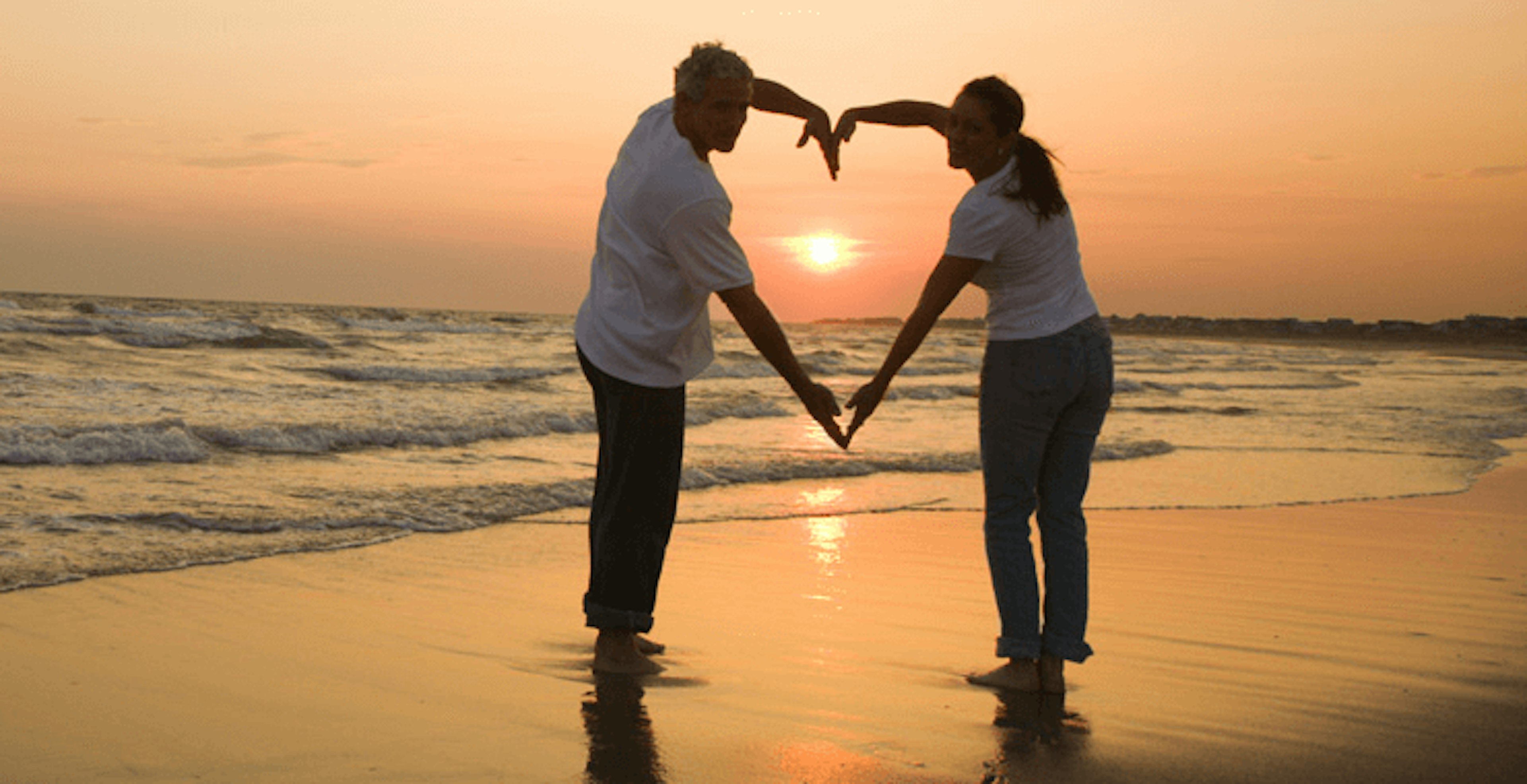 A couple holding hands on the beach