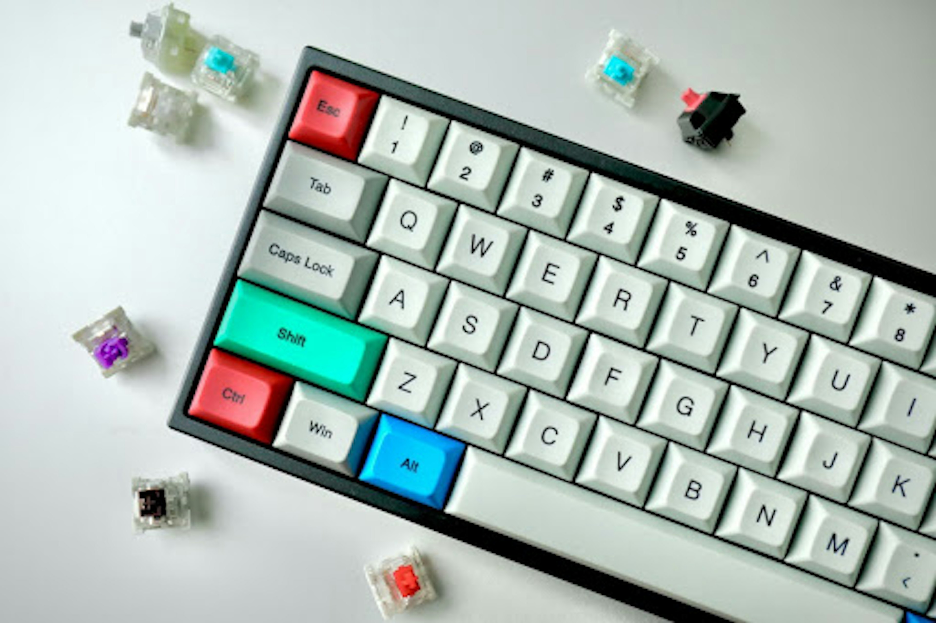 Keyboard with white, green, red, and blue keys. Image by Jay Zhang via Unsplash.