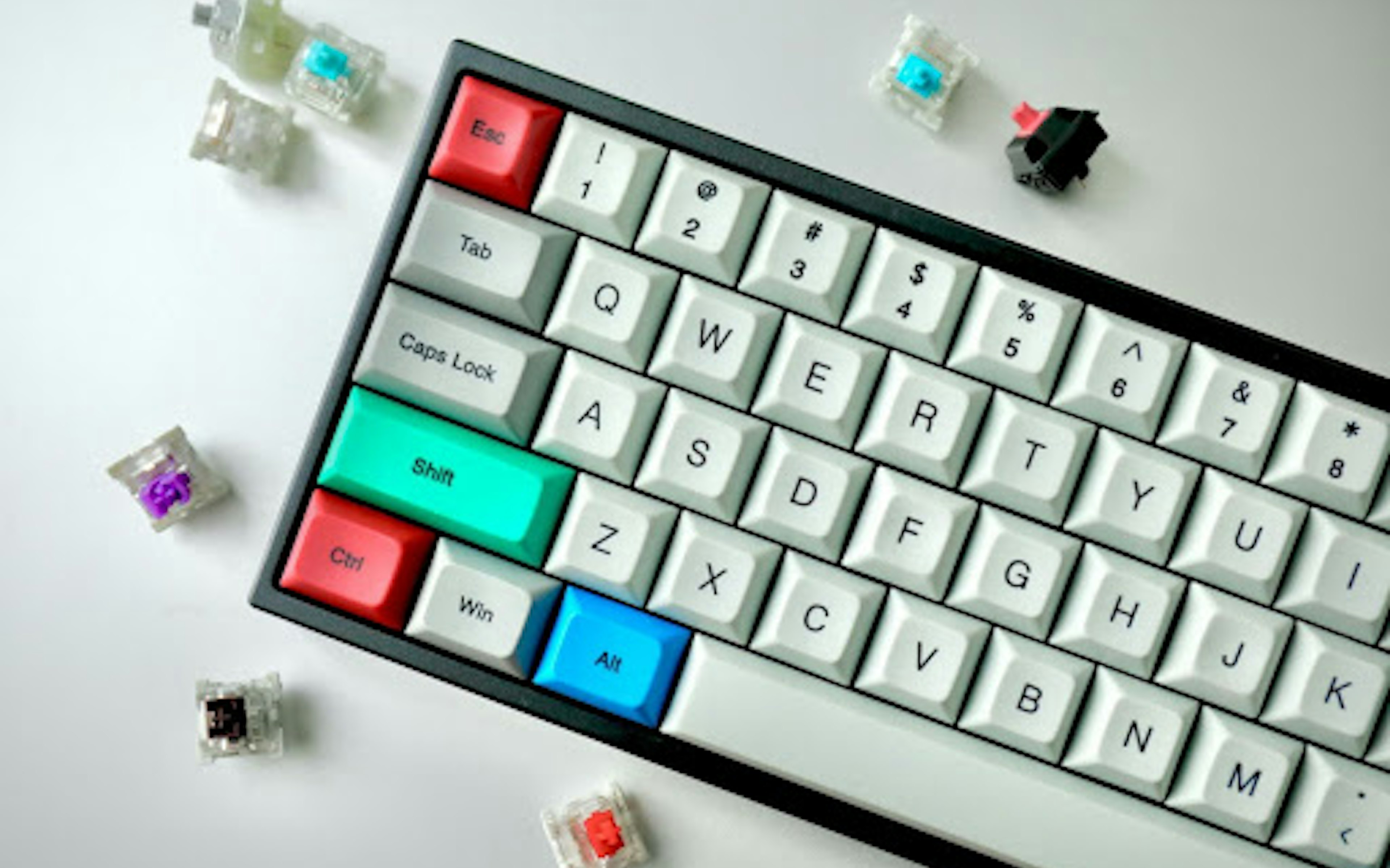 Keyboard with white, green, red, and blue keys. Image by Jay Zhang via Unsplash.